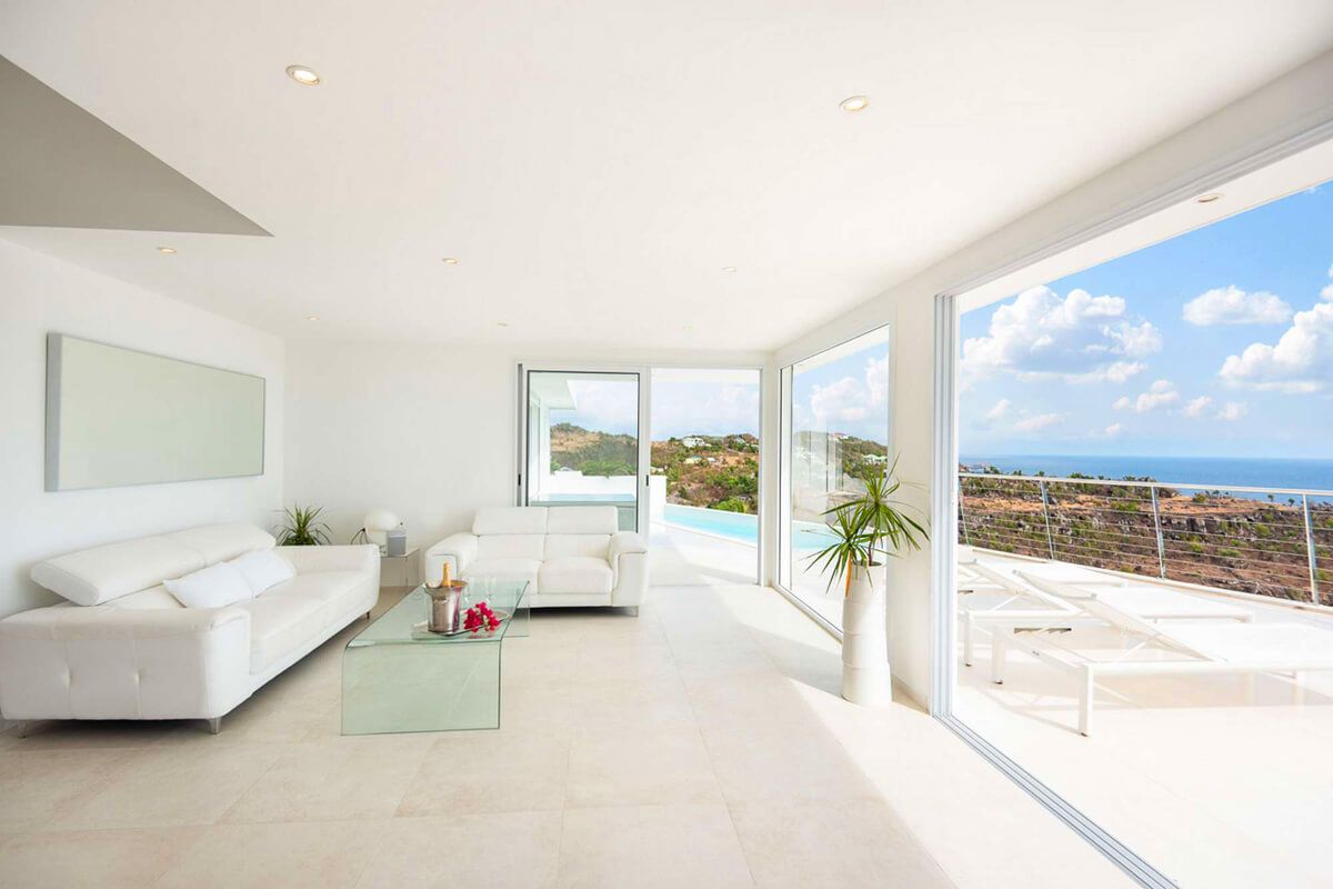 The living space opens to the patio through large glass doors
