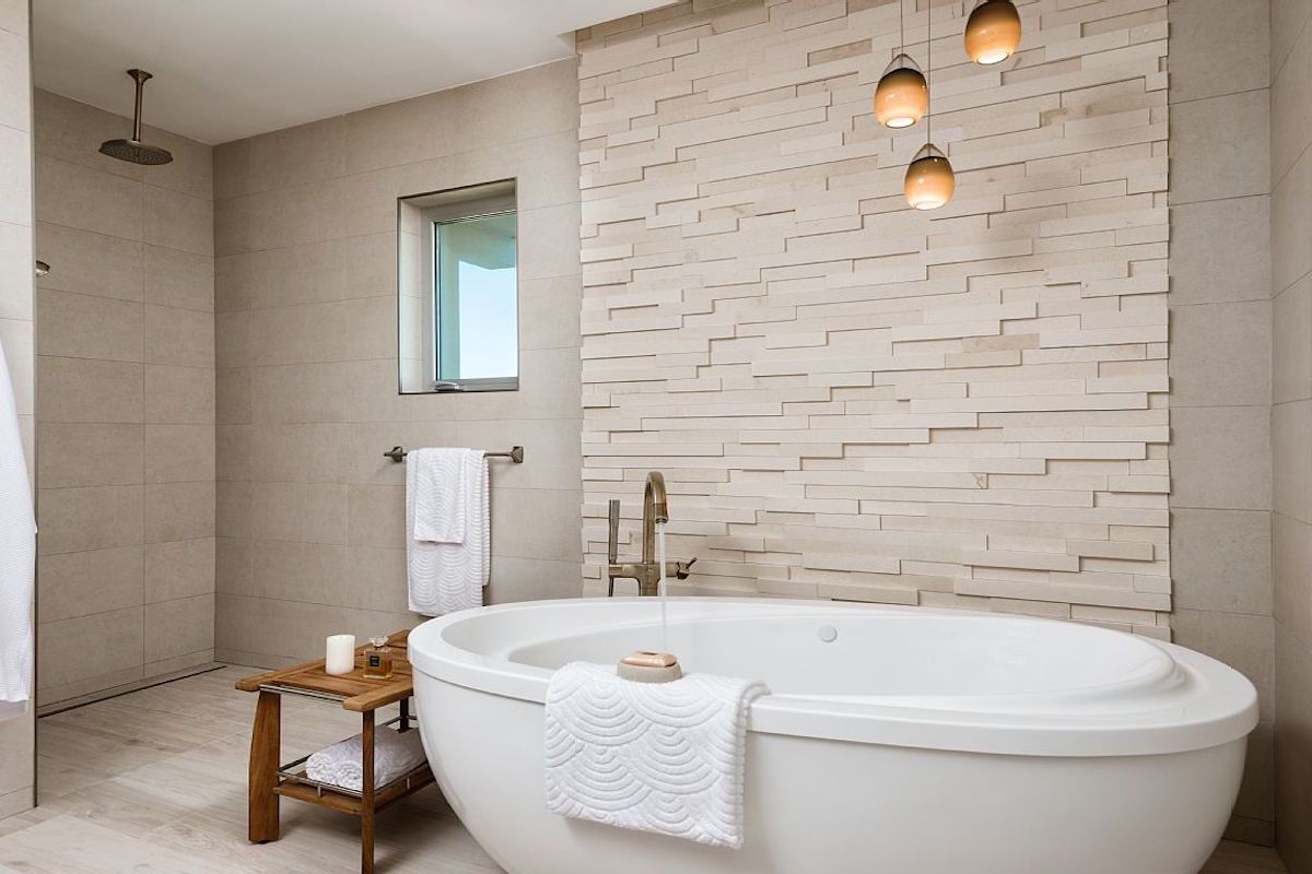 A luxurious soaking bath tub and rain head shower in the master bath room