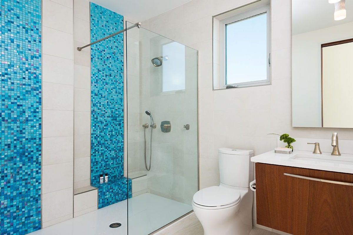 A single vanity bathroom with shower
