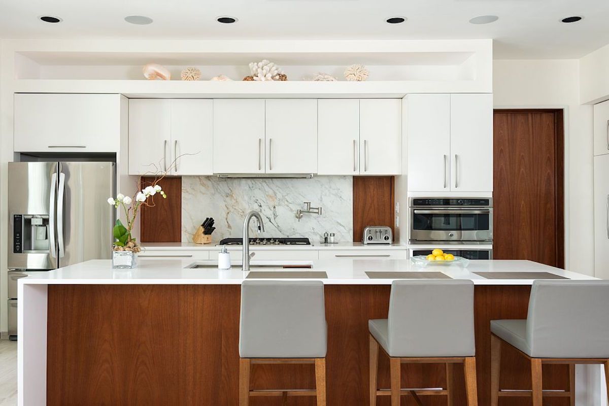 The kitchen has a breakfast bar that seats three